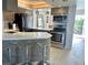 Modern kitchen with stainless steel appliances, quartz countertop, bar stool seating, and an open layout at 1401 S Mccall Rd # 106, Englewood, FL 34223