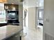 Well-lit kitchen with stainless steel appliances, breakfast bar, and views into the adjacent bedroom and living area at 1401 S Mccall Rd # 106, Englewood, FL 34223