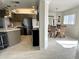 Open-concept kitchen and dining room with modern appliances, stylish lighting, and seating for six at 1401 S Mccall Rd # 106, Englewood, FL 34223