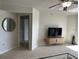 Bright living area with neutral walls, sleek flooring, and a modern media console enhancing its appeal at 1401 S Mccall Rd # 106, Englewood, FL 34223