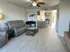 Comfortable living room featuring tile floors, modern decor, and open access to the kitchen and outdoor balcony at 1401 S Mccall Rd # 106, Englewood, FL 34223