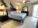 Comfortable main bedroom with a ceiling fan, and access to a balcony at 1401 S Mccall Rd # 106, Englewood, FL 34223