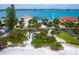 Stunning beachfront property with lush landscaping and turquoise water views at 1604 Casey Key Rd, Nokomis, FL 34275