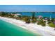 Stunning aerial view of beachfront properties with turquoise waters and pristine white sand creates a serene coastal panorama at 1604 Casey Key Rd, Nokomis, FL 34275