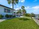 Spacious backyard lawn leading to a private dock and waterfront at 1604 Casey Key Rd, Nokomis, FL 34275