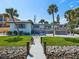 Backyard with a wooden deck, lawn, and a private dock leading to the water at 1604 Casey Key Rd, Nokomis, FL 34275