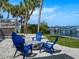 Cozy backyard firepit area with chairs and a water view at 1604 Casey Key Rd, Nokomis, FL 34275