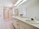 Bathroom featuring double sinks, a large mirror, and a glass-enclosed shower at 1604 Casey Key Rd, Nokomis, FL 34275