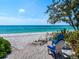Relaxing beach scene with chairs, white sand, and clear turquoise water at 1604 Casey Key Rd, Nokomis, FL 34275