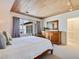 Bright bedroom with a lake view, wood ceiling, and wood furniture at 1604 Casey Key Rd, Nokomis, FL 34275