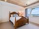Bright bedroom with a wood ceiling, lake views, and a wooden bed frame at 1604 Casey Key Rd, Nokomis, FL 34275