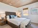 Charming bedroom featuring white bedding, a wicker headboard, and a wood ceiling at 1604 Casey Key Rd, Nokomis, FL 34275