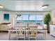 The dining room table is set for six and looks out over the water at 1604 Casey Key Rd, Nokomis, FL 34275