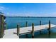 Dock view with a modern dock on the water, with shoreline in the background at 1604 Casey Key Rd, Nokomis, FL 34275