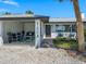 Charming home exterior with cozy seating area and well-manicured landscaping at 1604 Casey Key Rd, Nokomis, FL 34275