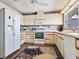 Bright kitchen with white cabinets and a floral rug at 1604 Casey Key Rd, Nokomis, FL 34275