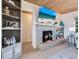 Cozy living room featuring a charming fireplace and built-in shelving at 1604 Casey Key Rd, Nokomis, FL 34275