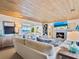 Cozy living room features a fireplace, comfortable seating, and stunning water views at 1604 Casey Key Rd, Nokomis, FL 34275