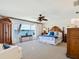 Bright main bedroom features a water view, wood furniture, and ceiling fan at 1604 Casey Key Rd, Nokomis, FL 34275