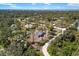Aerial view of the home's serene location amidst lush greenery and neighboring houses at 1871 Bridge St, Englewood, FL 34223