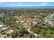 Aerial view of homes and community in a lush, wooded area near open water at 1871 Bridge St, Englewood, FL 34223