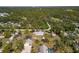 Bird's eye view of the property with mature trees and a single Gathering home at 1871 Bridge St, Englewood, FL 34223