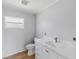 Bathroom showcasing grey walls, a toilet, and a vanity with a white countertop at 1871 Bridge St, Englewood, FL 34223