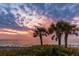 Scenic view of silhouetted palm trees against a vibrant sunset over the ocean at 1871 Bridge St, Englewood, FL 34223