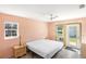 Bedroom needing some work showcasing peach walls, a bed, and exterior access at 1871 Bridge St, Englewood, FL 34223