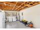 The garage houses the laundry, water heater, and features an exposed rafter ceiling at 1871 Bridge St, Englewood, FL 34223