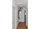 Hallway featuring laminate floors, a hot water heater, and a neutral color scheme at 1871 Bridge St, Englewood, FL 34223