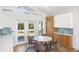 Spacious kitchen features island seating, modern cabinets, stainless appliances, and eating area at 1871 Bridge St, Englewood, FL 34223