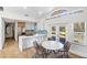 Bright kitchen with a center island, stainless steel appliances, and an adjacent dining area with seating at 1871 Bridge St, Englewood, FL 34223