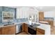 Well-lit modern kitchen featuring stainless steel appliances, blue backsplash, and ample counter space for cooking at 1871 Bridge St, Englewood, FL 34223