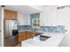 An open kitchen featuring stainless appliances, ample counter space, and an eat-in dining area at 1871 Bridge St, Englewood, FL 34223