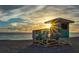 Quaint lifeguard stand on sandy beach against the sun rising on the horizon at 1871 Bridge St, Englewood, FL 34223