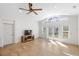 Bright living space featuring a ceiling fan, and view into the yard through double doors at 1871 Bridge St, Englewood, FL 34223