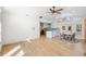 Bright living room featuring tile floors, a modern fan, and an adjacent kitchen area with white cabinetry at 1871 Bridge St, Englewood, FL 34223