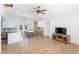 Open-concept living area with modern flooring, ceiling fan, breakfast bar and lots of natural light at 1871 Bridge St, Englewood, FL 34223