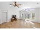 Open living room featuring wood floors, a ceiling fan, and french doors leading to the backyard at 1871 Bridge St, Englewood, FL 34223