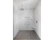 Bathroom featuring a shower with marble-patterned walls, a shower head, and a bench at 1871 Bridge St, Englewood, FL 34223