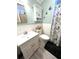 Cozy bathroom featuring a white vanity, toilet and shower with a fish-themed shower curtain and decor at 199 Palm Harbor Dr, North Port, FL 34287