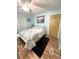 Comfortable bedroom featuring a queen bed and warm wood-look flooring at 199 Palm Harbor Dr, North Port, FL 34287