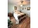 Spacious bedroom featuring light green walls, wood-look flooring, and a ceiling fan at 199 Palm Harbor Dr, North Port, FL 34287