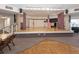 A large stage area with curtains, lighting, and American flags in a community recreation center at 199 Palm Harbor Dr, North Port, FL 34287