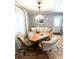 Inviting dining area featuring a wooden table, comfortable seating, and a charming sideboard against neutral walls at 199 Palm Harbor Dr, North Port, FL 34287