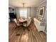 Cozy dining room with a wooden table set for four, complemented by a sideboard and soft natural lighting at 199 Palm Harbor Dr, North Port, FL 34287