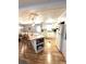 Bright kitchen featuring an island with seating, ample storage, and modern appliances set against wood-look flooring at 199 Palm Harbor Dr, North Port, FL 34287