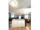 Bright, open kitchen with large island, pendant lighting, and seamless flow into living and dining areas at 199 Palm Harbor Dr, North Port, FL 34287