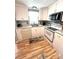 Cozy kitchen featuring white cabinets, modern appliances, and a window above the sink for natural light at 199 Palm Harbor Dr, North Port, FL 34287
